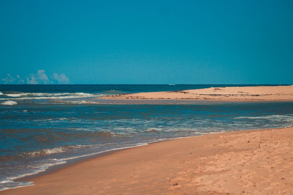 Quiet sandy shoreline meeting a calm sea