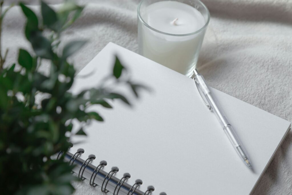 Notebook and eucalyptus branches on a calm workspace